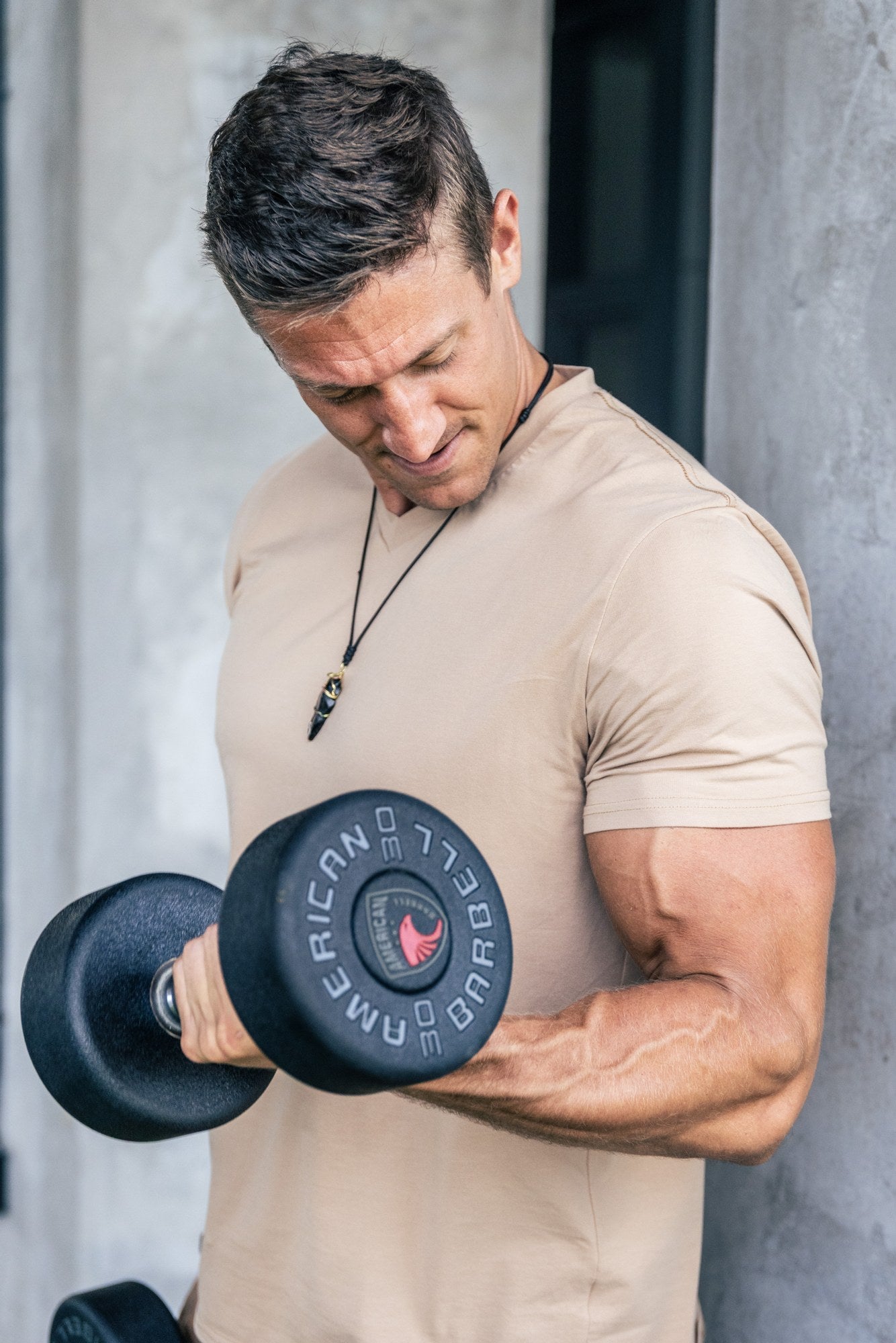 Man doing a dumbbell curl in the gym for the Androgen Advantage eight-week strength program